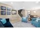 Bright living room with teal accent chairs and a navy couch at 43815 W Carey Dr, Maricopa, AZ 85138