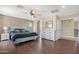 Bright main bedroom featuring a teal bed frame and plenty of floor space at 43815 W Carey Dr, Maricopa, AZ 85138