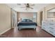 Spacious main bedroom with a teal bed frame and light grey dresser at 43815 W Carey Dr, Maricopa, AZ 85138