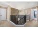 Upstairs hallway with a modern staircase and stone accent wall at 43815 W Carey Dr, Maricopa, AZ 85138