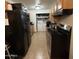 Kitchen with black appliances and laundry area at 4417 N 70Th Ave, Phoenix, AZ 85033