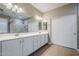 Bright bathroom features a dual sink vanity with white cabinets and a tiled walk-in shower at 4647 E County Down Dr, Chandler, AZ 85249