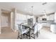 Eat-in kitchen with white cabinets, granite countertops, and a breakfast table at 4647 E County Down Dr, Chandler, AZ 85249