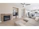 Living room with fireplace, TV, and view into the kitchen and dining area at 4647 E County Down Dr, Chandler, AZ 85249