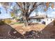 Large backyard with mature tree, gravel, and patio at 4749 E Evergreen St, Mesa, AZ 85205