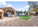 Backyard with patio, pergola, artificial turf and rock landscaping at 4749 E Evergreen St, Mesa, AZ 85205