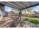 Backyard with covered patio, artificial turf, and storage shed at 4749 E Evergreen St, Mesa, AZ 85205