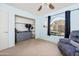 Bedroom with large window, ceiling fan, dresser, and closet at 4749 E Evergreen St, Mesa, AZ 85205