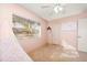 Bright bedroom with window, ceiling fan, and neutral walls at 4749 E Evergreen St, Mesa, AZ 85205