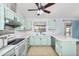 L-shaped kitchen with light green cabinets and white appliances at 4749 E Evergreen St, Mesa, AZ 85205