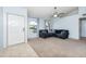 Living room with a sectional sofa and neutral carpeting at 4749 E Evergreen St, Mesa, AZ 85205