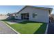 Home exterior and backyard with artificial turf and fire pit at 5080 N 184Th Ln, Litchfield Park, AZ 85340