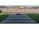 Landscaped backyard featuring artificial turf and fire pit at 5080 N 184Th Ln, Litchfield Park, AZ 85340