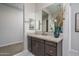 Primary bathroom with granite countertops and large mirror at 5080 N 184Th Ln, Litchfield Park, AZ 85340