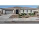 Single-story home with gray exterior, stone accents, and landscaping at 5080 N 184Th Ln, Litchfield Park, AZ 85340