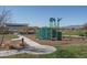 Community playground with modern play structures and a shaded area at 5080 N 184Th Ln, Litchfield Park, AZ 85340