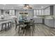 Open dining area with gray cabinets, granite countertops, and wood flooring provides a warm and inviting space at 5249 E Thunderbird Rd, Scottsdale, AZ 85254