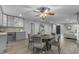 An open-concept dining area includes a beverage cooler, wood flooring, and an elegant chandelier at 5249 E Thunderbird Rd, Scottsdale, AZ 85254