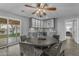 Bright dining area features modern gray cabinets, granite countertops, and a unique chandelier over the wooden table at 5249 E Thunderbird Rd, Scottsdale, AZ 85254