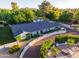 Aerial view of a well-maintained home with mature landscaping, a new roof, and a circular driveway at 5249 E Thunderbird Rd, Scottsdale, AZ 85254