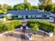 Charming single-story home with a manicured front yard, white picket fence, and lush greenery at 5249 E Thunderbird Rd, Scottsdale, AZ 85254