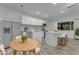 Bright kitchen with stainless steel appliances, white cabinets, island, and a cozy dining area at 5249 E Thunderbird Rd, Scottsdale, AZ 85254