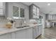 Bright kitchen with stainless steel appliances, stylish granite countertops, and under-cabinet lighting at 5249 E Thunderbird Rd, Scottsdale, AZ 85254