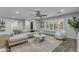 A well-lit living room features modern decor, wood floors, and plantation shutters at 5249 E Thunderbird Rd, Scottsdale, AZ 85254