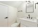 Modern half-bathroom with a decorative mirror, white vanity, and updated fixtures at 7326 N 43Rd Ave, Glendale, AZ 85301