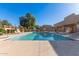 Inviting community pool area with lounge chairs, umbrellas, and a covered seating space at 7326 N 43Rd Ave, Glendale, AZ 85301