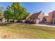 Well-manicured lawn and garden, complemented by cozy townhomes with red-tiled roofs at 7326 N 43Rd Ave, Glendale, AZ 85301