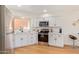 Well-lit kitchen with stainless steel appliances, white cabinets, and elegant countertops at 7326 N 43Rd Ave, Glendale, AZ 85301