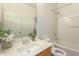 This bathroom features a shower-tub combo and a sink with a wood cabinet at 7420 W Glass Ln, Laveen, AZ 85339