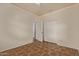 Bedroom with tile floors, ceiling fan, and double doors leading to another room at 7420 W Glass Ln, Laveen, AZ 85339