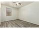 Bright bedroom with ceiling fan, light walls, gray flooring, and a window at 7420 W Glass Ln, Laveen, AZ 85339