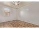 Simple bedroom with tile floors and ceiling fan at 7420 W Glass Ln, Laveen, AZ 85339