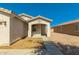 Close up view of the front entrance with a covered porch and trimmed lawn at 7420 W Glass Ln, Laveen, AZ 85339