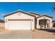 One-story house with a two-car garage and desert landscaping at 7420 W Glass Ln, Laveen, AZ 85339