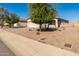 Landscaped front yard of a single-story house with a garage at 7420 W Glass Ln, Laveen, AZ 85339