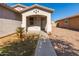 Front entryway with a walkway and small landscaping at 7420 W Glass Ln, Laveen, AZ 85339