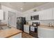 Well-equipped kitchen with stainless steel appliances and white cabinets at 7420 W Glass Ln, Laveen, AZ 85339