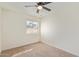 Spacious bedroom with ceiling fan and large window at 7448 N 43Rd Dr, Glendale, AZ 85301