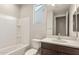 Bright bathroom featuring a tub-shower combo and modern vanity with stone countertop at 7659 W Cactus Wren Way, Florence, AZ 85132