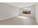 This bedroom has neutral walls, a large window, and a tiled floor at 7659 W Cactus Wren Way, Florence, AZ 85132