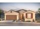 One-story home with Spanish-style architecture, brown garage door, and red shutters at 7659 W Cactus Wren Way, Florence, AZ 85132