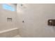 A shower space with neutral colored tiling, a built-in seat, and a shower-head at 7659 W Cactus Wren Way, Florence, AZ 85132