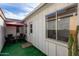 Cozy backyard patio with artificial turf, outdoor seating, and a view of the home's exterior at 7810 N 47Th Ave, Glendale, AZ 85301