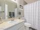 Bathroom featuring a vanity, tile counter, decorative shower curtain, and sink at 7810 N 47Th Ave, Glendale, AZ 85301