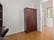 Bedroom with hardwood floors features a built-in wardrobe and access to the hallway at 7810 N 47Th Ave, Glendale, AZ 85301