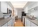 Well-lit kitchen featuring stainless steel appliances, white cabinets, and ample storage at 7810 N 47Th Ave, Glendale, AZ 85301